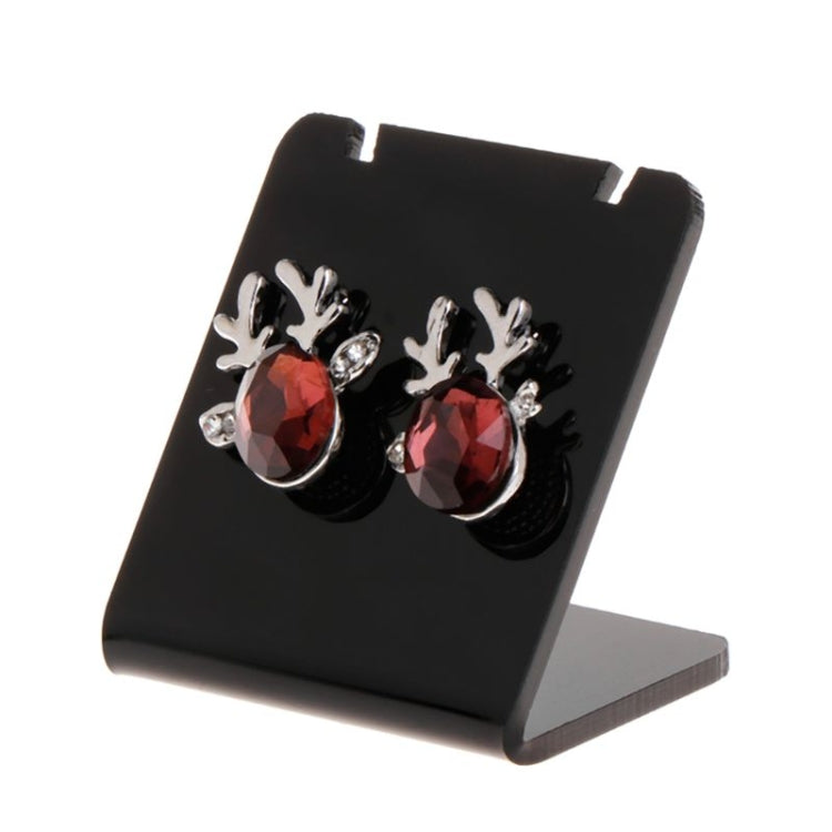 Black acrylic earring display stand holding a pair of red crystal stud earrings