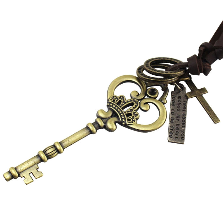 Crown key pendant detail with heart charm, hanging tag, and cross key charm