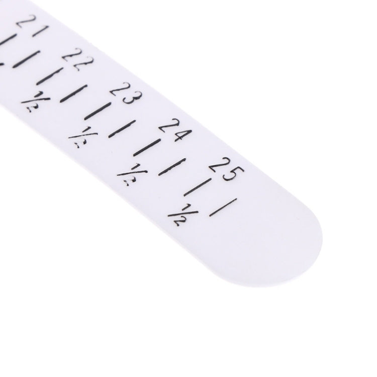 White measuring strip for bracelet sizing with printed numbered scale and tick marks