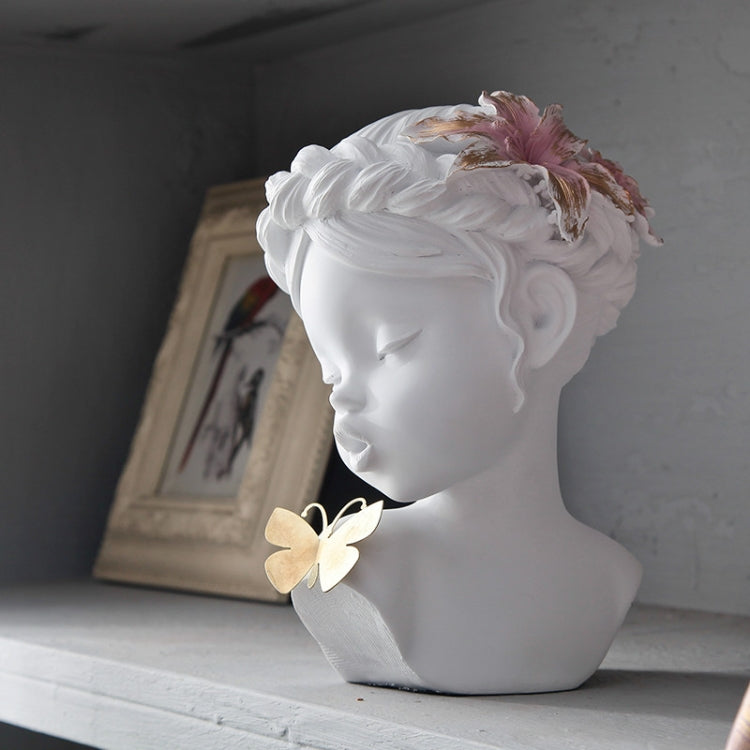 White resin bust statue in side view with pink floral hair and butterfly ornament
