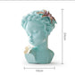 Aqua resin bust statue with butterfly ornament and floral hair, 16cm x 24cm