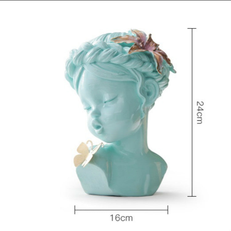 Aqua resin bust statue with butterfly ornament and floral hair, 16cm x 24cm