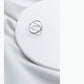 Polished sterling-silver tone open cross ring, thin band on white fabric.