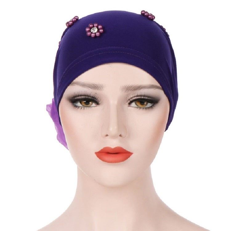 Beaded dark purple turban hat with small flower pin on the top