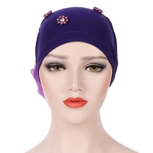 Beaded dark purple turban hat with small flower pin on the top