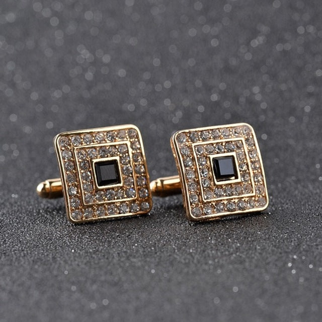 Gold-tone square cufflinks with rhinestone border, black center, on bar backing