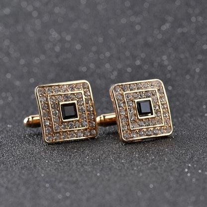 Gold-tone square cufflinks with rhinestone border, black center, on bar backing