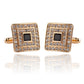 Gold-tone square cufflinks pair with rhinestone frame and black square center