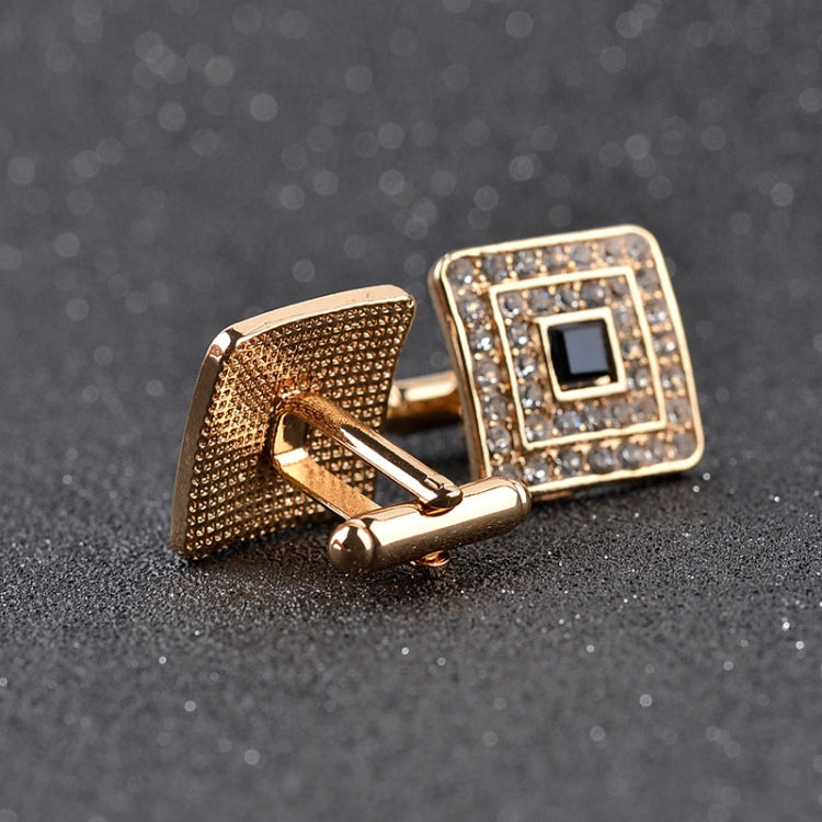 Gold-tone cufflinks with textured back and square rhinestone face, black center
