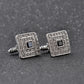 Silver-tone square cufflinks pair with black center and glittering rhinestone border