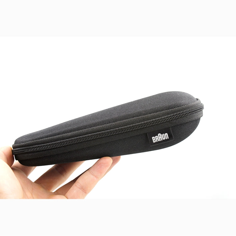 Black long zippered shaver case held in hand