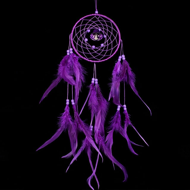 Purple dream catcher wall hanging with woven hoop, bell charm, and long feather tassels