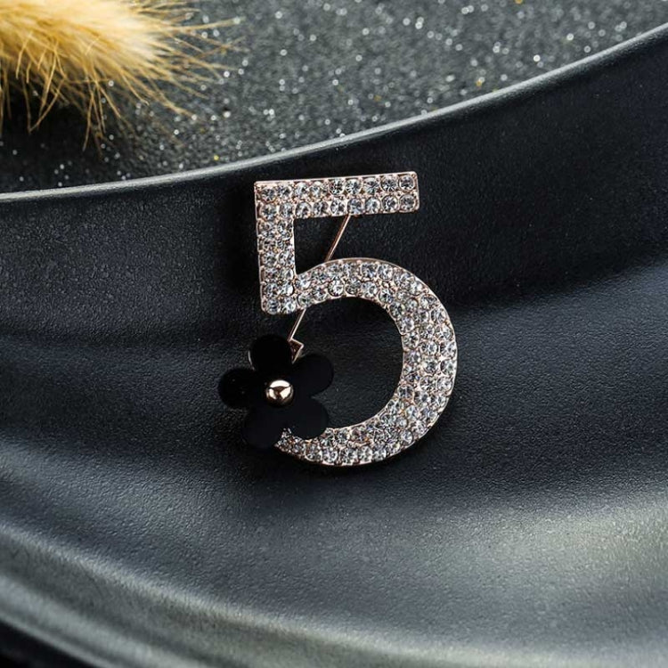 Sparkly number 5 brooch with black flower detail, rose-gold tone metal setting