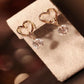 Gold heart hoop earrings with sparkling round crystal dangles