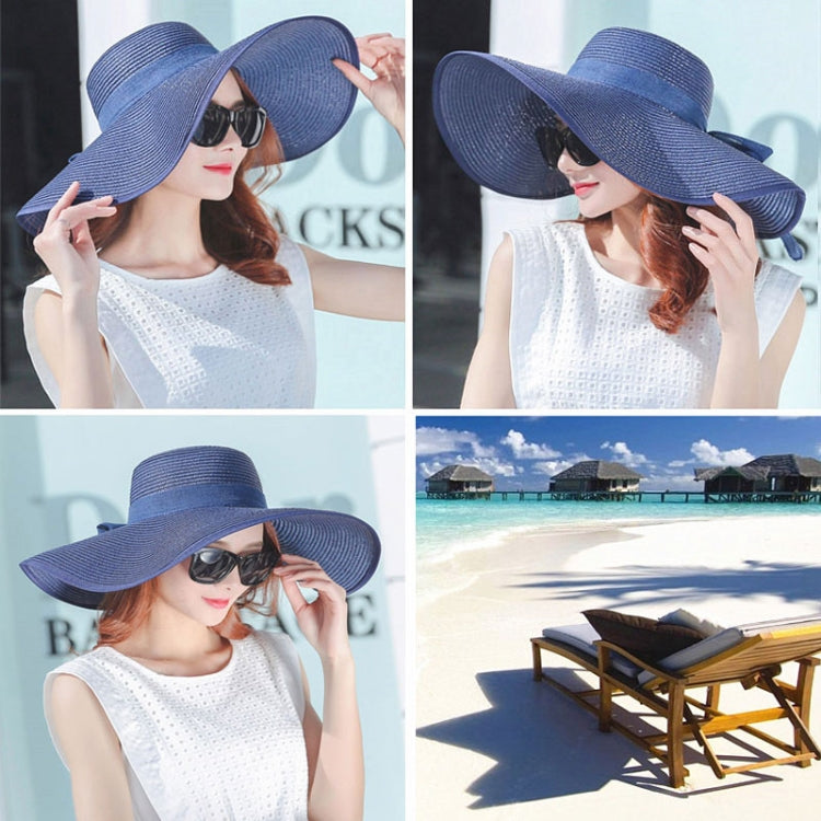 Foldable wide-brim sun hat, navy blue straw with tied bow and wide brim