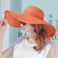 Foldable wide-brim sun hat, orange straw with extra-wide floppy brim and bow
