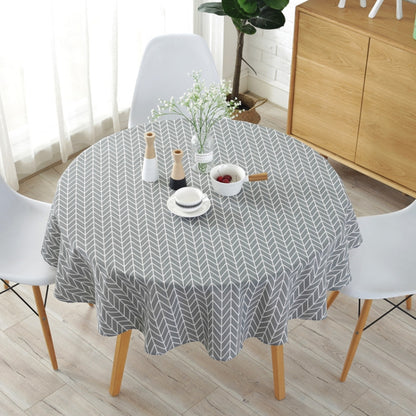 Gray round tablecloth with white chevron leaf pattern draped over a dining table