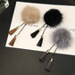 Set of fur ball chain tassel brooches in black, gray, and tan with tassels