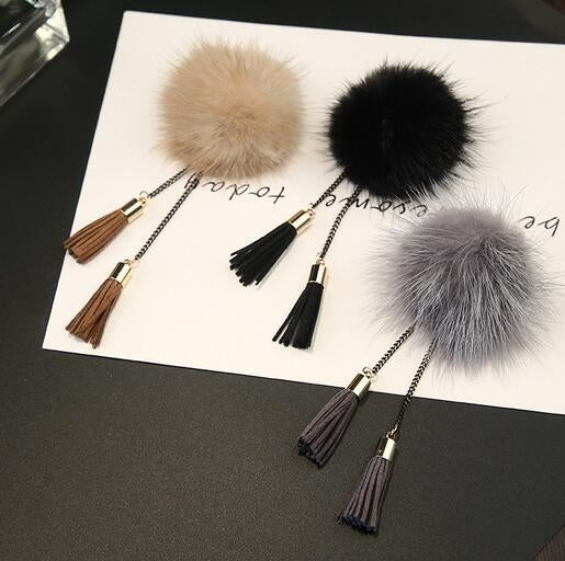 Set of fur ball chain tassel brooches in black, gray, and tan with tassels