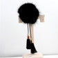 Black fur ball chain tassel brooch with gold hardware and dangling black tassels