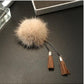 Cream fur ball chain tassel brooch with brown tassels and gold connector caps