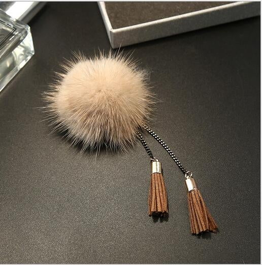 Cream fur ball chain tassel brooch with brown tassels and gold connector caps