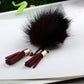 Dark burgundy fur ball chain tassel brooch with burgundy tassels and black chain