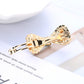 Gold rhinestone hair barrette close-up with hinged clip