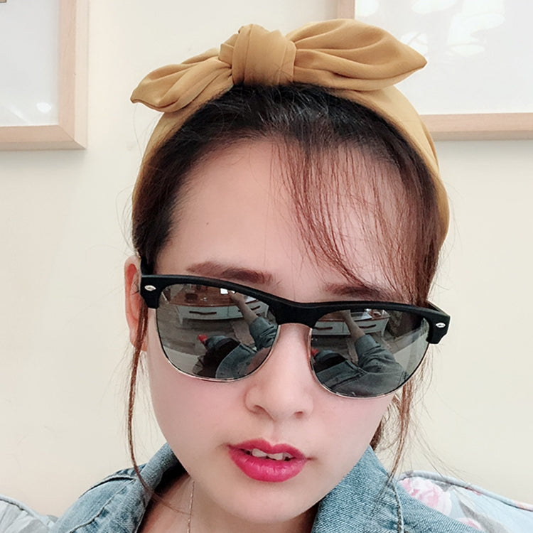 Beige rabbit-ear bow headband with large knotted bow, front-worn on hair