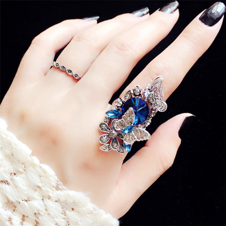 Blue butterfly crystal statement ring with thin band on hand