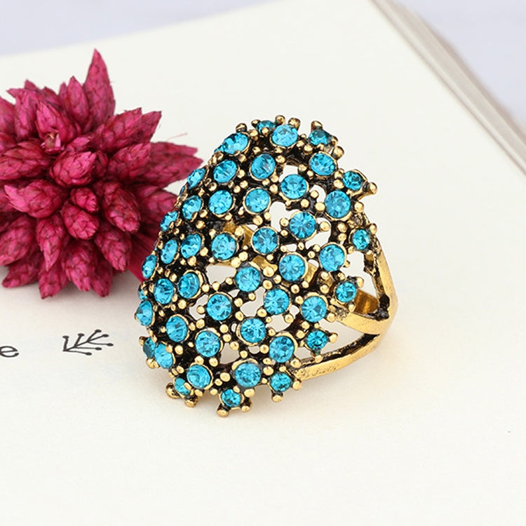 Blue rhinestone cluster ring with gold-tone setting, side view