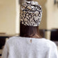 Women’s letter-print turban cap, beige with black pattern, rear view