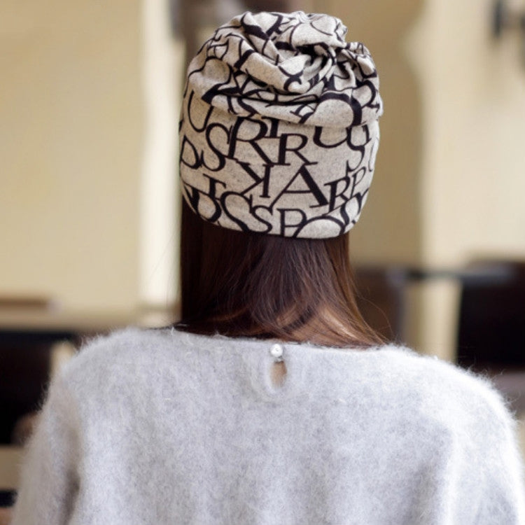 Women’s letter-print turban cap, beige with black pattern, rear view