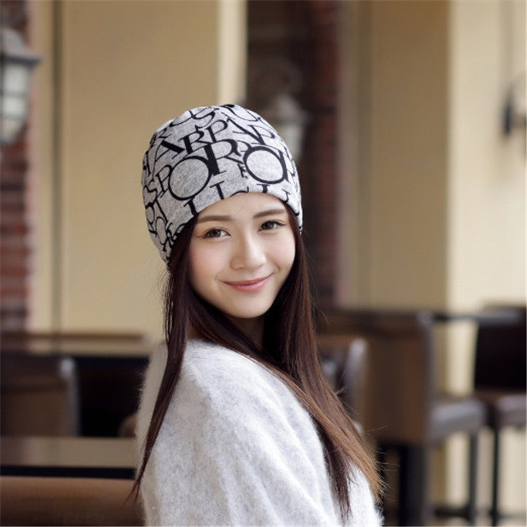 Women’s letter-print turban cap, beige with black graphic pattern, angled portrait