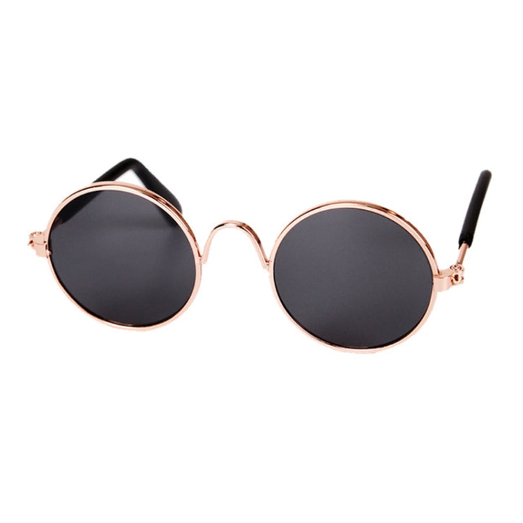 Round pet sunglasses with black lenses, rose-gold frame, and black ear stems