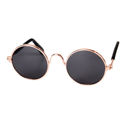 Round pet sunglasses with black lenses, rose-gold frame, and black ear stems