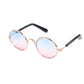 Round pet sunglasses with light pink reflective lenses, rose-gold frame, black stems
