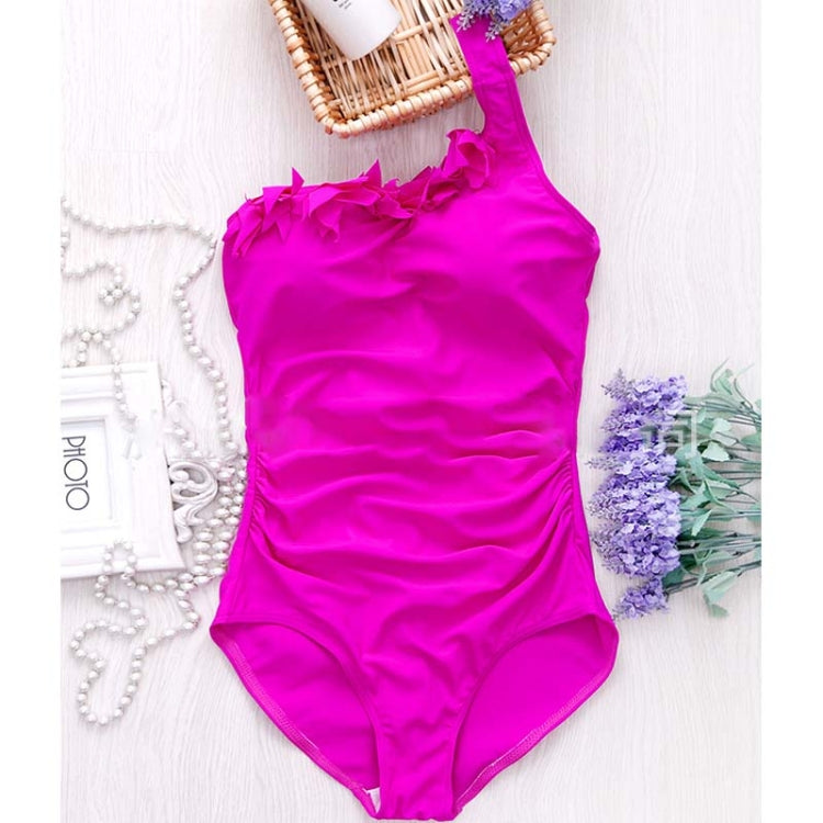 Fuchsia one-piece swimsuit with one-shoulder ruffled neckline, flat lay on white background