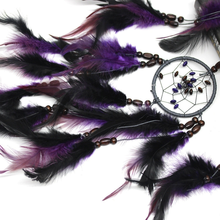 Close-up of purple and black feathers with small beaded dream catcher hoops