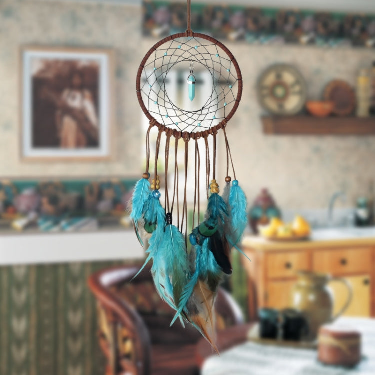 Dreamcatcher wall hanging with turquoise feathers and teal drop charm on white web