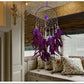 Purple dreamcatcher wall hanging with round hoop web, bead drops, and feather tassels.