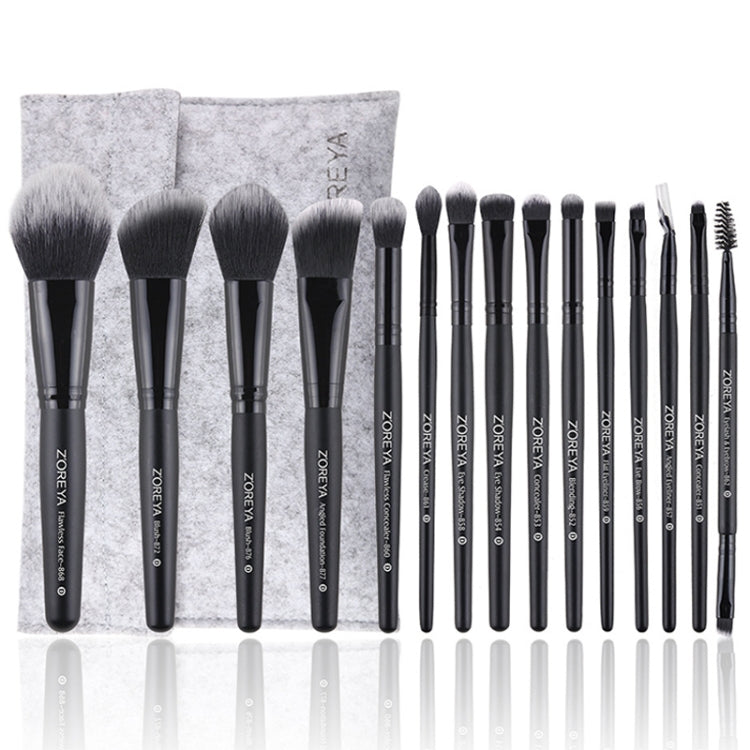 Makeup brush set with soft black bristles, black handles, and gray fabric storage pouch