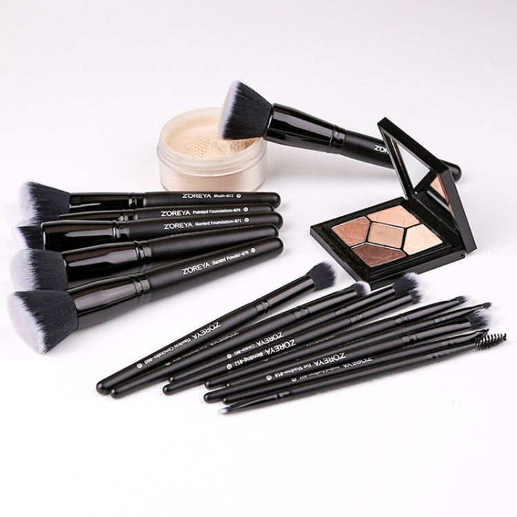 Makeup brush set with soft black bristles and black handles, shown with a compact palette