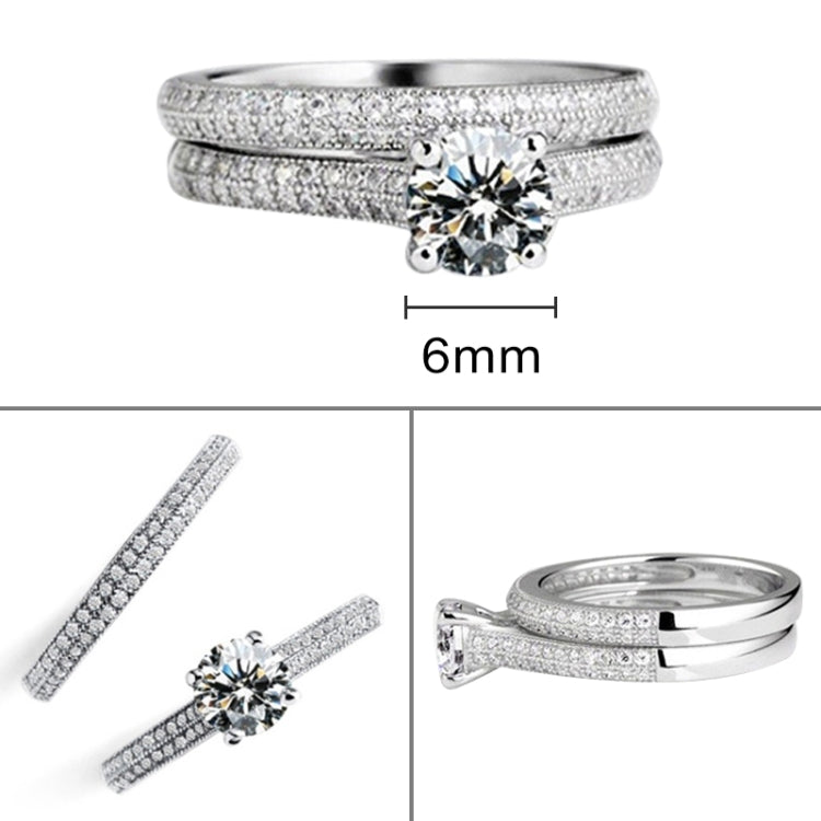 Silver double-row zircon wedding ring with round center stone, flat lay view