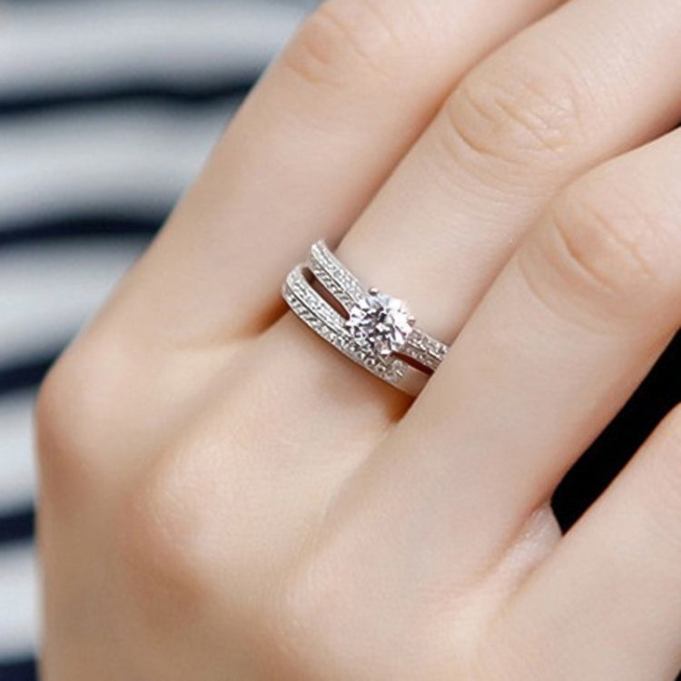 Silver double zircon wedding band with center round stone, close-up on fingers