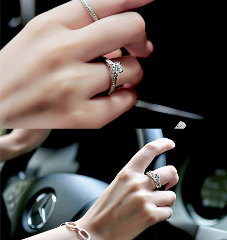 Silver zircon wedding ring on finger with square-like setting and round center stone