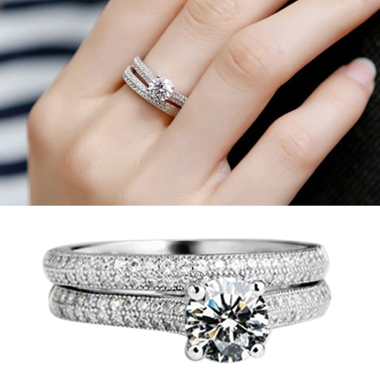Silver double zircon wedding ring set with clear stones on a hand