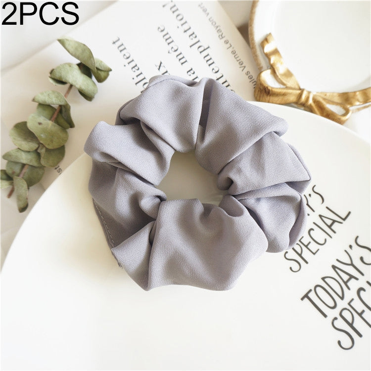 Gray fabric scrunchie hair tie with large ruffled swirl for seamless ponytail hold