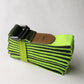 Lime green cotton resistance band with black stripes and metal buckle, folded