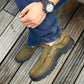 Brown suede hiking sneaker with pull tab and rugged treaded sole